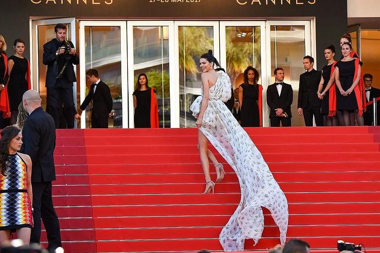 Supermodel Kendall Jenner on the Cannes red carpet in sheer socks and sandals.