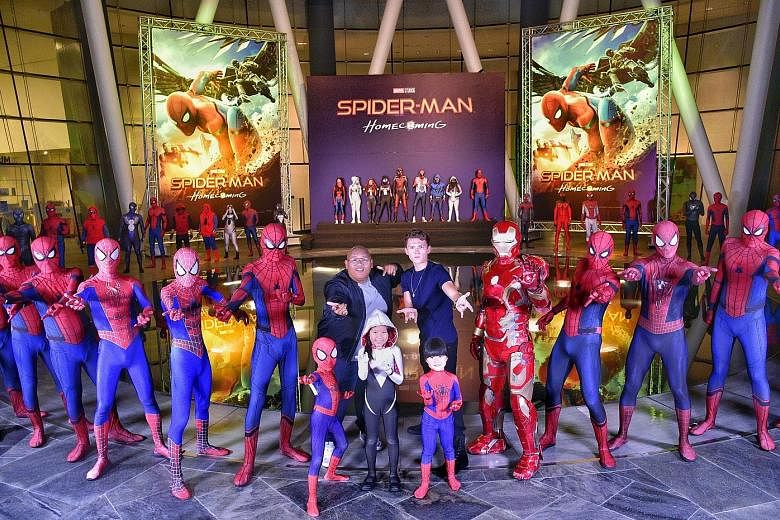The stars of upcoming movie Spider-Man: Homecoming Jacob Batalon (centre left) and Tom Holland posing with costumed Spider-Man fans after the closed-door, red-carpet event for the movie. The actors are in town for a few days to promote the latest fil