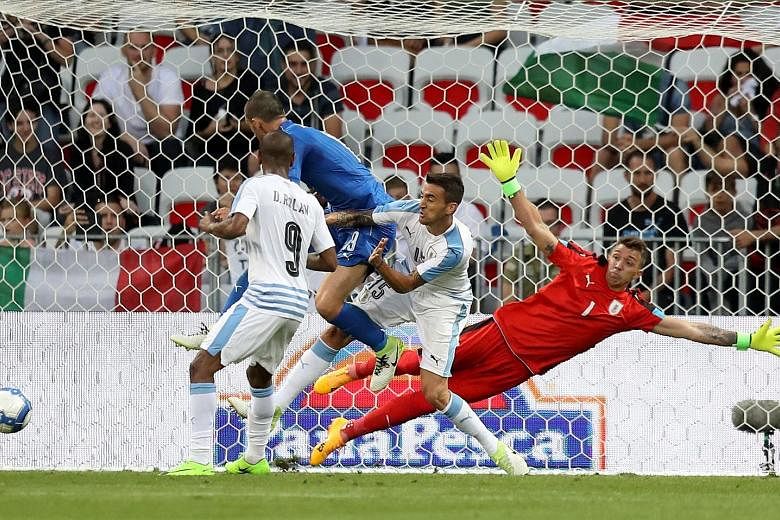 Uruguay goalkeeper Fernando Muslera diving in vain as defender Jose Gimenez (not in picture) scores an own goal in the friendly versus Italy. The Azzurri will be in a confident mood ahead of their World Cup qualifier against minnows Liechtenstein.
