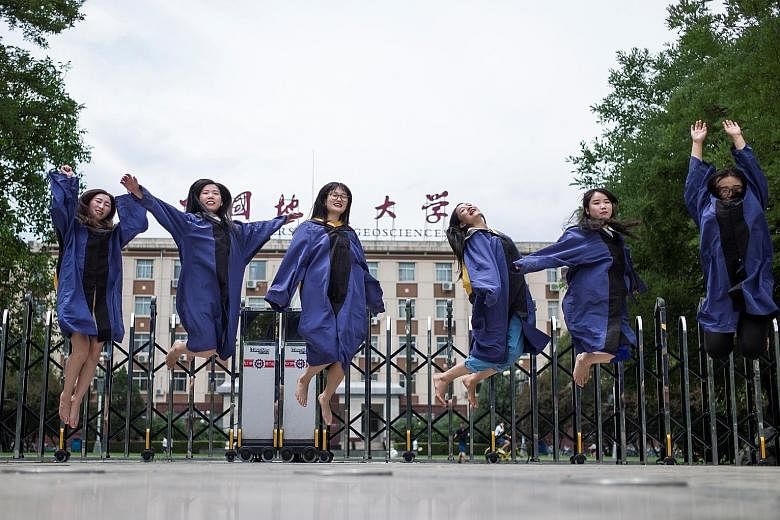 Graduates posing for a picture after earning their master's degrees from the China University of Geosciences in Beijing yesterday. The school is regarded as a top university and its notable alumni include Mr Wen Jiabao, the former premier, who attend