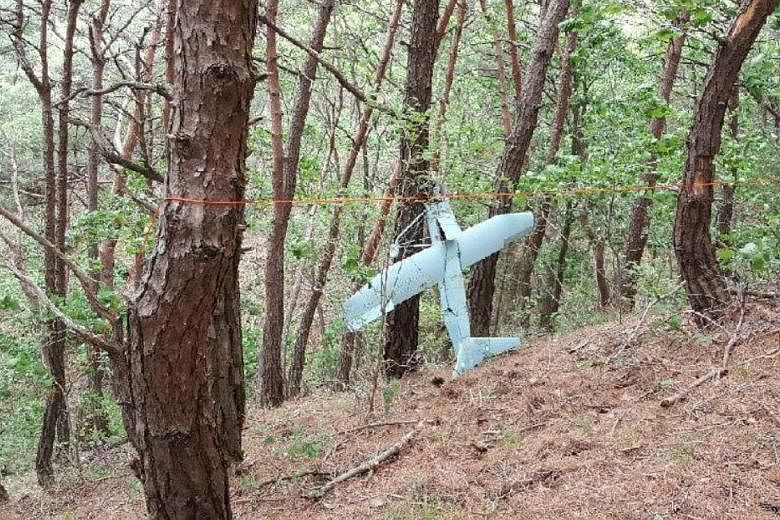 A small aircraft believed to be a North Korean drone found on a mountain near the demilitarised zone, in a photograph provided by the South's Defence Ministry yesterday.