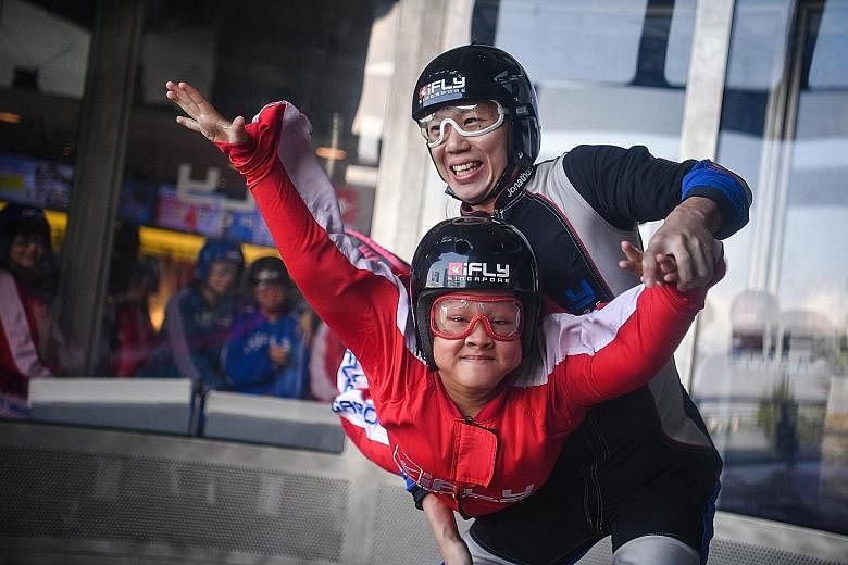 Natasha Lee Ann, 17, who suffers from Kabuki Syndrome, getting a taste of skydiving at iFly Singapore yesterday. She was among the participants of the Order of Malta Inaugural Asia Pacific Summer Camp who got a chance to try out the extreme sport. Th