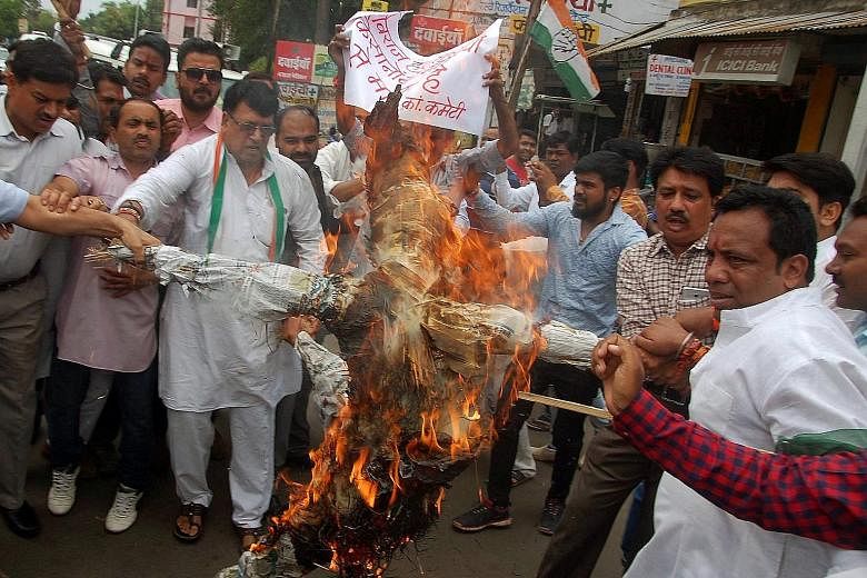 Demonstrators burning an effigy of Madhya Pradesh Chief Minister Shivraj Singh Chouhan at a protest organised by the opposition Congress party in the state capital of Bhopal on Wednesday.