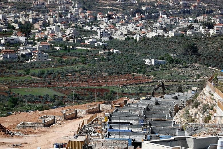 A March 31 photo showing the Palestinian West Bank village of Turmus Ayya and homes being built in the Jewish settlement of Shilo (foreground). Settlements are illegal under international law and are a major obstacle to the two-state solution.
