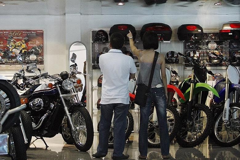 Customers at Mah Motors' motorcycle showroom. FWD's motorcycle insurance recognises safe riders by providing an option to retain and pay the same premium for two years, and a lifetime 20 per cent no claim discount guarantee as long as they are insure