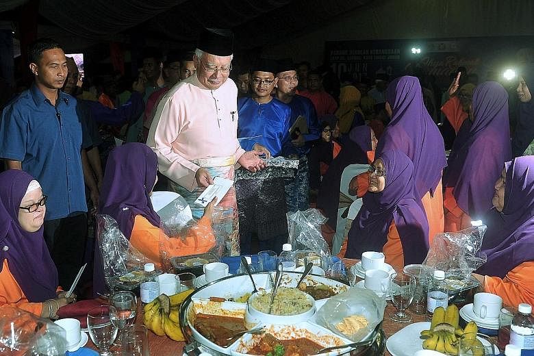 Malaysian Prime Minister Najib Razak attending a breaking of fast programme with settlers at Felda Bukit Sayong in Johor yesterday.