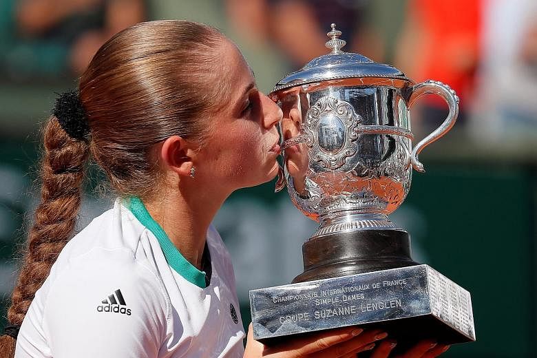Two days after her 20th birthday, Latvia's Jelena Ostapenko celebrates her shock 4-6, 6-4, 6-3 victory over Simona Halep to win the French Open yesterday.