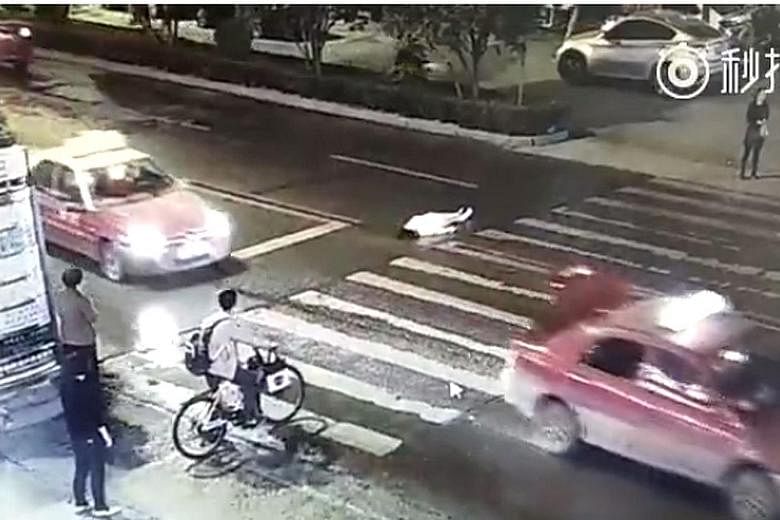 A video of a woman in China being hit by a taxi and then run over by an SUV - while other pedestrians and motorists did nothing - has reignited a debate about social cohesion in the country.