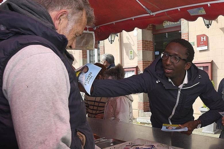 Mr Herve Berville distributing his manifesto in the market of Pleneuf-Val-Andrelast Tuesday. Just 27, he was snapped up last month by President Emmanuel Macron's political movement, La Republique en Marche, to run for a seat in Parliament. Mr Bervill