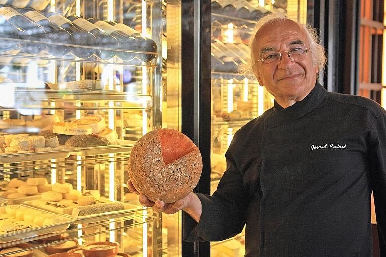 Cheese master Gerard Poulard holding a block of Mimolette, one of 50 varieties of cheeses he brought for a showcase at Ginett Restaurant & Wine Bar in Hotel G.