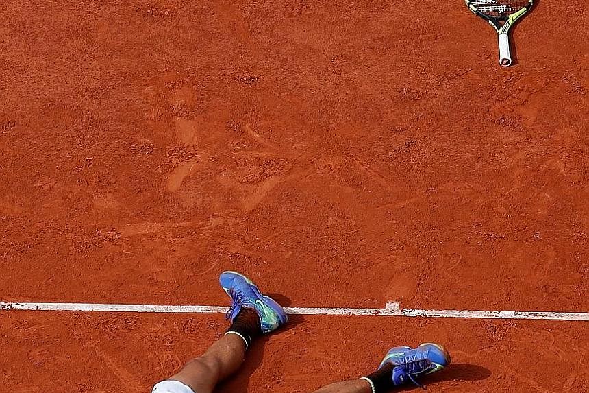 Rafael Nadal celebrates his 6-2, 6-3, 6-1 demolition of Stan Wawrinka in the French Open final yesterday. The Spaniard did not drop a set during the fortnight and is the first player in the Open era to have won a single Grand Slam tournament 10 times