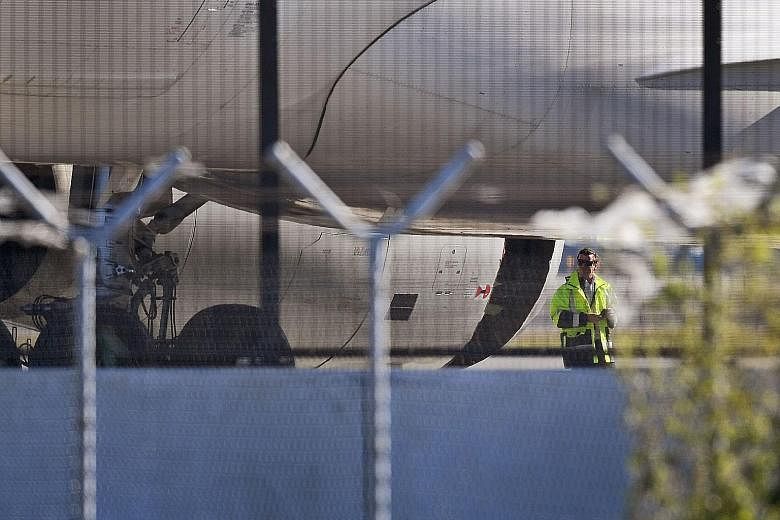 The China Eastern Airbus A-330 plane with the damaged engine cowling at Sydney Airport yesterday. The aircraft made an emergency landing after a huge hole appeared in an engine casing.