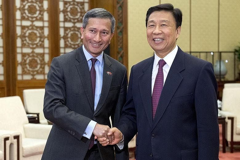 Foreign Minister Vivian Balakrishnan with his Chinese counterpart Wang Yi in Beijing yesterday. China welcomes Singapore's participation in the Belt and Road Initiative, said Mr Wang. Dr Vivian Balakrishnan calling on Chinese V-P Li Yuanchao in Beiji