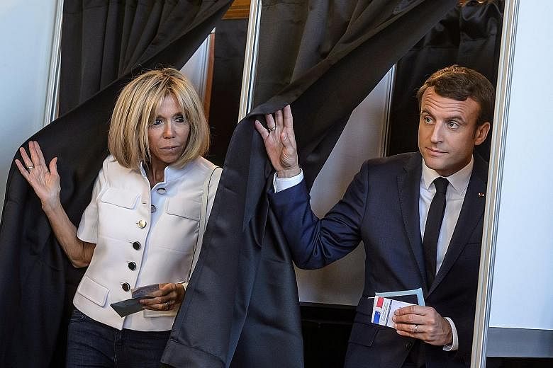 French President Emmanuel Macron and his wife Brigitte casting their ballots in Le Touquet in the first round of parliamentary elections. Supporters of French President Emmanuel Macron's Republique En Marche party cheering in Paris after polls closed