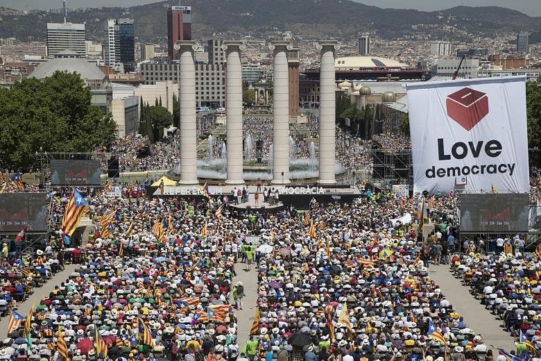Tens of thousands of demonstrators at a rally in support of the independence referendum in Montjuic, Barcelona, in the Catalonia region of Spain, on Sunday. The issue has put civil servants in Catalonia - who are needed to help organise the vote - in