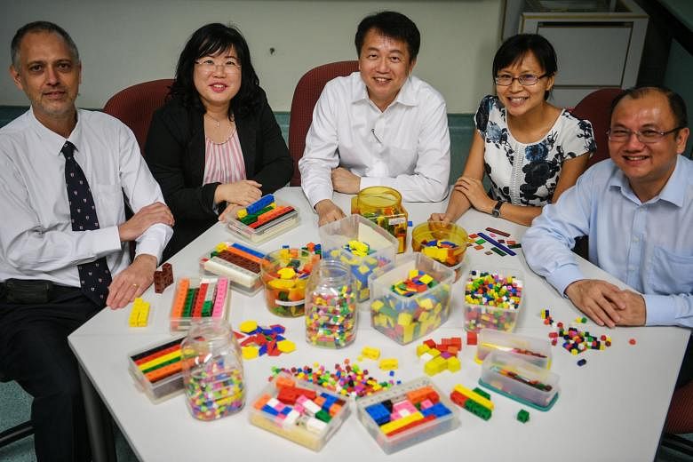 (From left) Dr Paul Shutler, Dr Dawn Ng, Associate Professor Lee Ngan Hoe, Dr Cheng Lu Pien and Dr Joseph Yeo from NIE, with learning tools used for teaching the Singapore maths model method. They are designing teaching materials for Australia, which will
