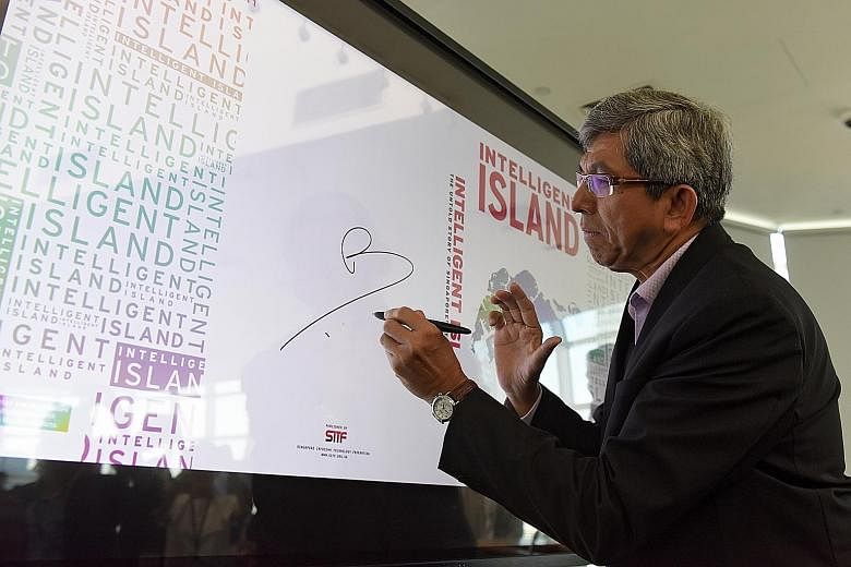 Dr Yaacob Ibrahim, Minister for Communications and Information, signing an interactive screen to launch the book.