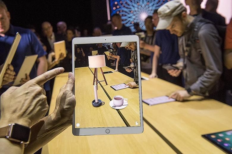 A participant checking out the ARKit augmented reality tool on a new iPad Pro at the Apple Worldwide Developers Conference in San Jose, California, last week. The 10.5-inch iPad Pro is powered by the new Apple A10X Fusion chip, which Apple claims is 