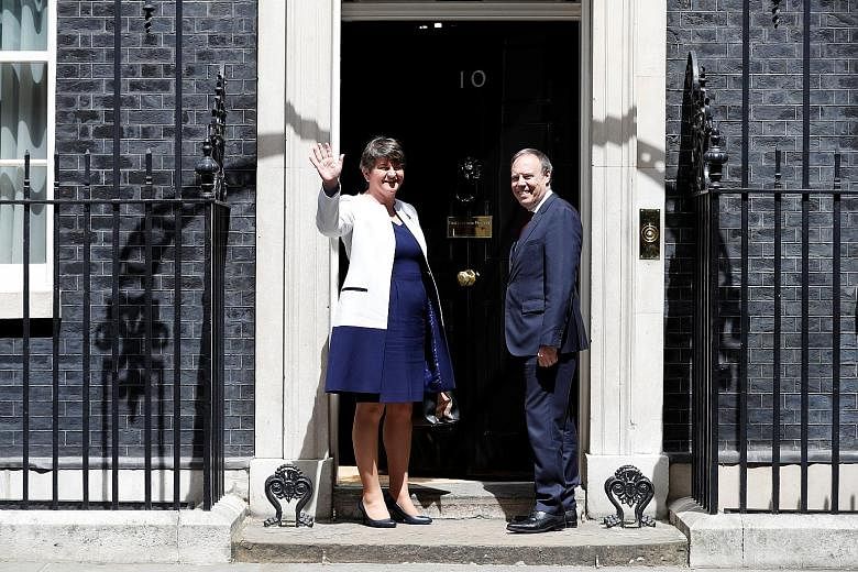 DUP leader Arlene Foster and deputy leader Nigel Dodds on the steps of 10 Downing Street before heading in for talks with Britain's Prime Minister Theresa May. Mrs May is counting on the DUP, with 10 MPs, to support her Conservative government.