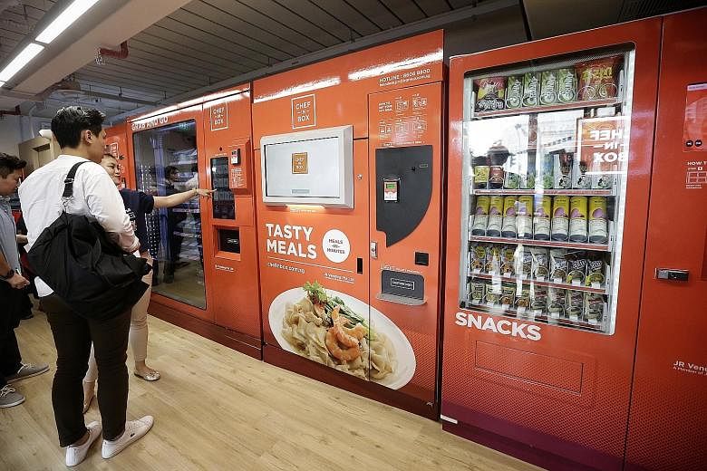 Commuters needing a bite can pick from a wide range of items (below) including soups, cake, wraps and rice dishes from the vending machines at Ang Mo Kio MRT station (left).
