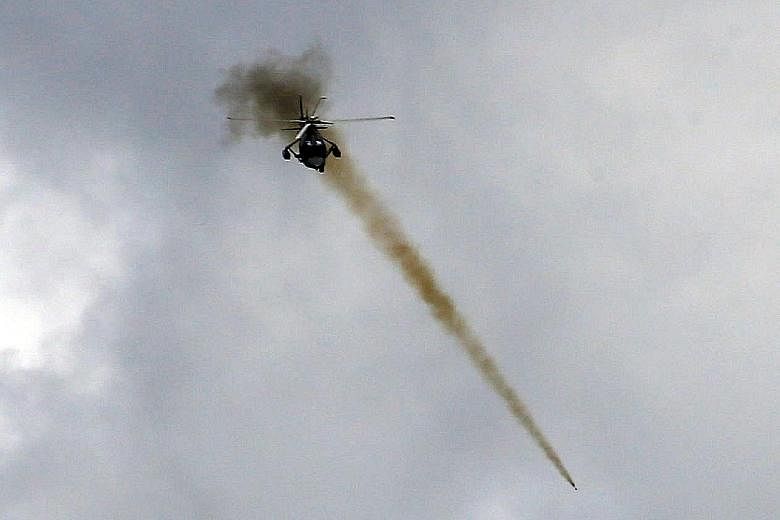 A Philippine Air Force helicopter launching a rocket as government troops continued their assault on Marawi yesterday.