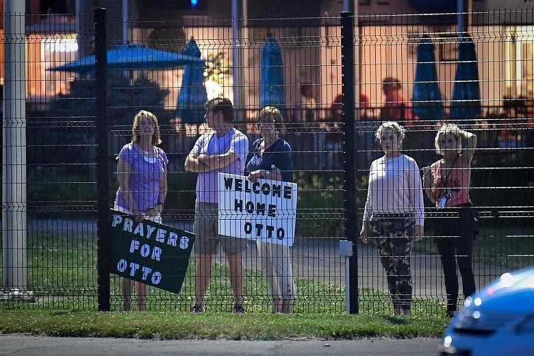 Local residents waiting to welcome home Mr Otto Warmbier at Lunken Airport in Cincinnati, Ohio, on Tuesday. The American was freed by North Korea 18 months into a 15-year sentence, and is said to be in bad shape. He was flown to a medical centre upon