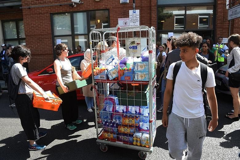 Volunteers arriving with supplies for residents. At least 12 people are dead and more than 70 others injured. London police said the death toll is likely to rise.