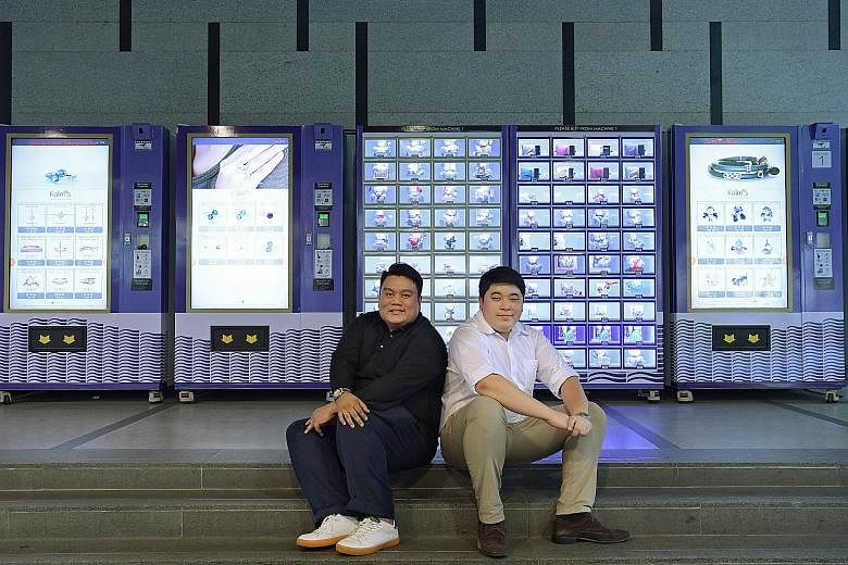 Kalms (Singapore) chief executive Azan Tengku (left) and operations manager Masataka Mukai beside the company's cluster of "automated retail machines" at International Plaza.