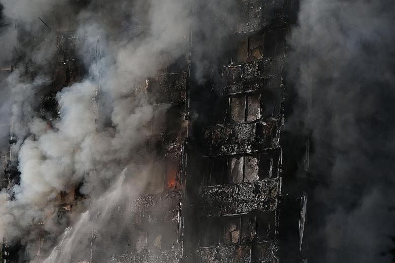 Thick smoke billowing from Grenfell Tower yesterday. The fire brigade said the inferno engulfed all floors from the second storey to the top of the block. The cause of the fire was not immediately known. A trapped resident waiting for help in Grenfel