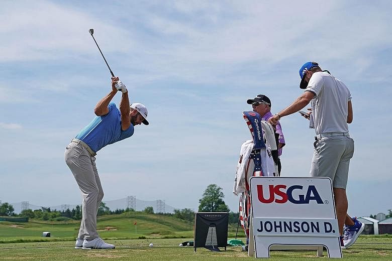 World No. 1 Dustin Johnson hitting a shot during a practice round at Erin Hills. Uncertainty over a possible penalty stroke lingered over the American at last year's US Open, putting the status of the leaderboard in doubt before he pulled away for an
