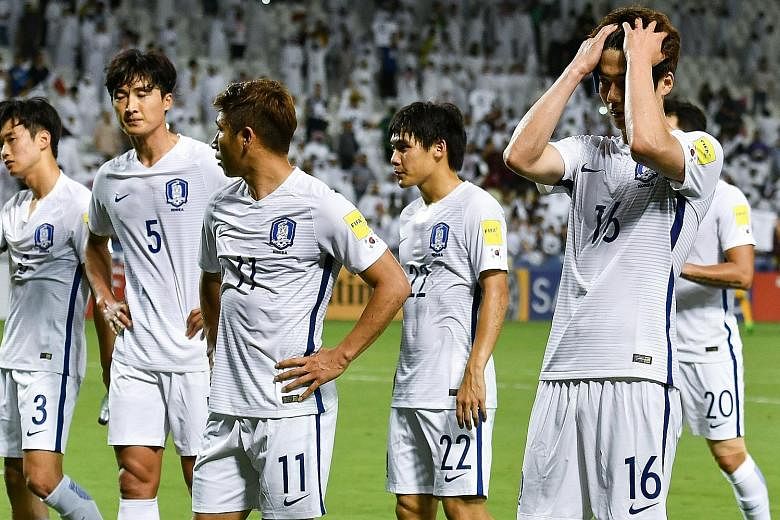 Left: The body language of South Korea's players says it all after they were beaten 3-2 in a World Cup qualifier on Tuesday by Qatar. It was their first loss to the Arab nation in 32 years and national coach Uli Stielike (above) was sacked by the Kor