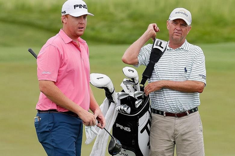 American golfer Dru Love (left) and his father Davis Love III working together during a practice round ahead of the US Open.