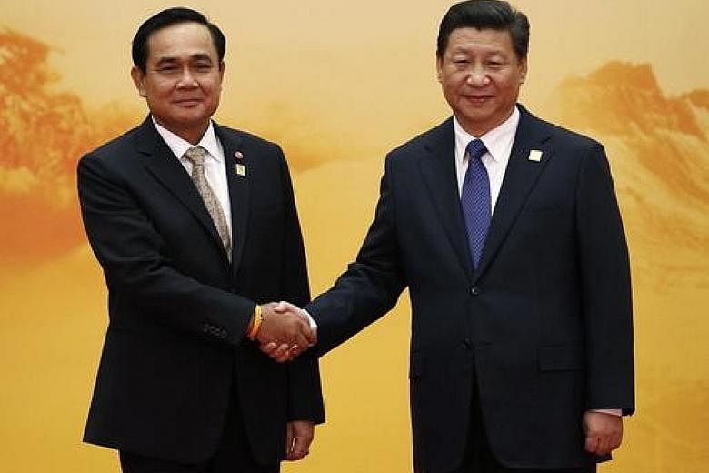 Thai Premier Prayut Chan-o-cha (at left) with Chinese President Xi Jinping at the Asia-Pacific Economic Cooperation forum in 2014. Bangkok is strengthening its ties with Beijing.