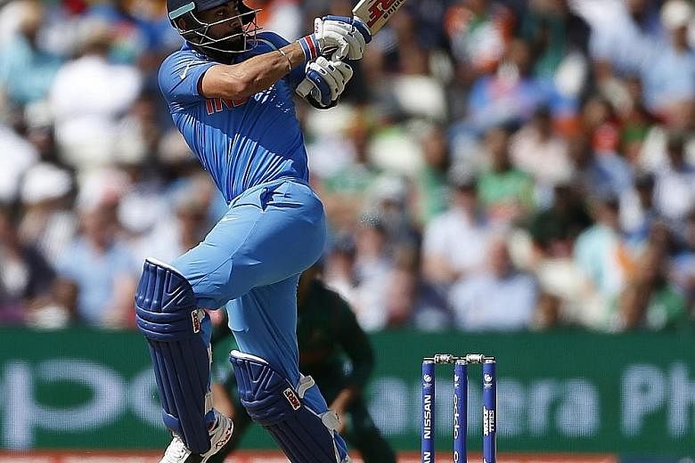 India's Virat Kohli in action during the semi-final match against Bangladesh in which his team won by nine wickets. Kohli hit an unbeaten 96 from 78 balls to become the fastest batsman to 8,000 one-day runs from 175 innings and passed the 182 it took