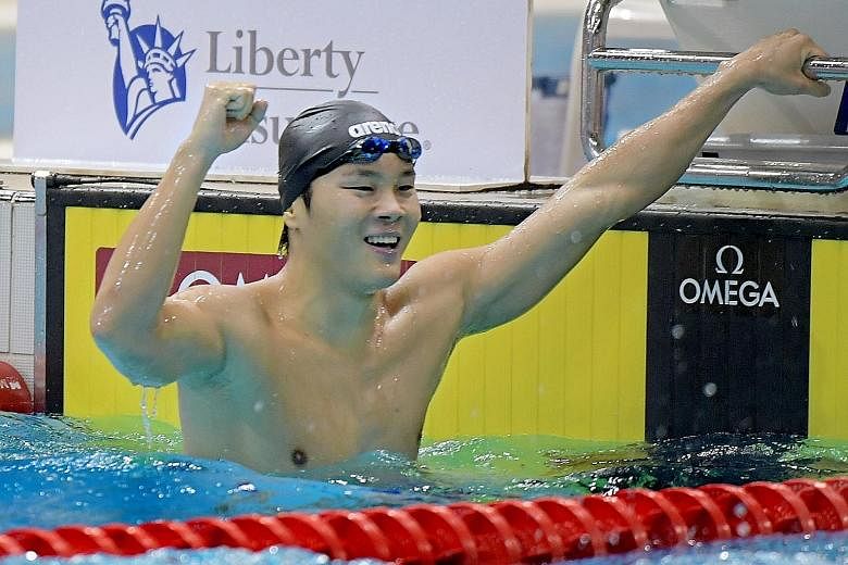 Above: Pang Sheng Jun celebrating his win in the 400m individual medley at the 13th Singapore National Swimming Championships yesterday. Left: Zachary Ian Tan swimming in the 400m individual medley at the OCBC Aquatic Centre.