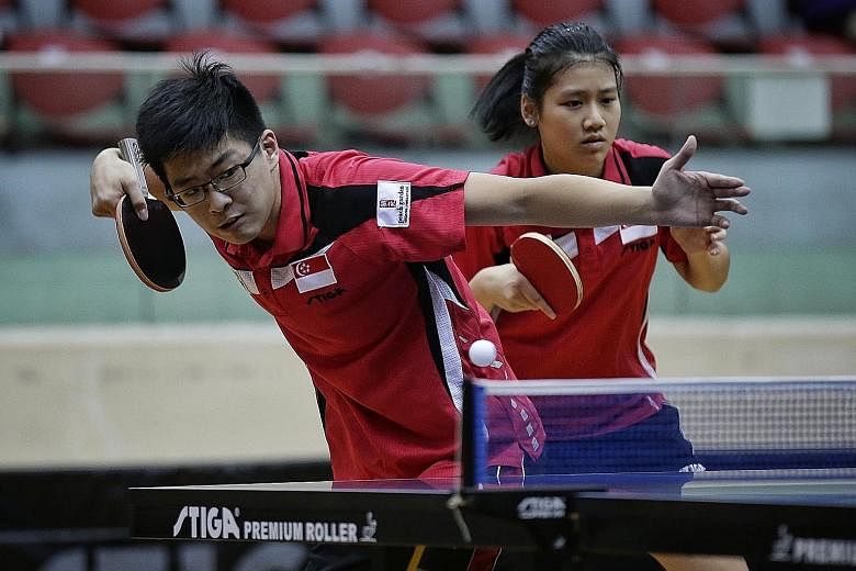 Singapore's Ethan Poh and Wong Xin Ru in action against compatriots (not pictured) Gerald Yu and Goi Rui Xuan in their junior mixed doubles final of the South-east Asian Junior and Cadet Table Tennis Championships yesterday.
