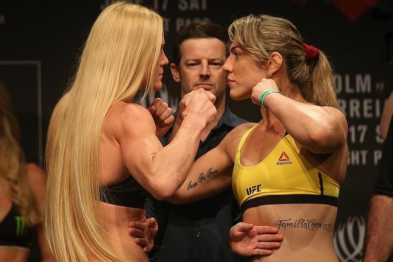 American Holly Holm (left) and Bethe Correia of Brazil face off before their main event at UFC Fight Night Singapore today. The fight will take place at the Singapore Indoor Stadium.