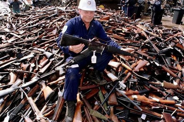 A security firm supervisor with an armalite rifle - similar to the one used in the 1996 Port Arthur massacre - and other weapons handed in to be scrapped in the aftermath of the mass shooting. The new national amnesty, which will run from July 1 to S