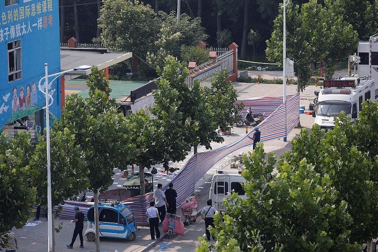 The area outside the kindergarten in Jiangsu province where an explosion took place on Thursday was cordoned off as police investigated the blast. They found materials for making an explosive device in the suspect's room and words such as "die" writt