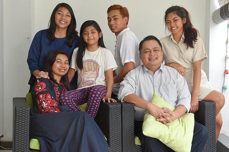 School teacher Norharyati Hassan and Nahar Azmi Abdul Majid with their children (from left) Sarah Nahar Azmi, 14; Zahra Nahar Azmi, eight; Faris Nahar Azmi, 19, and Nadhrah Nahar Azmi, 17. Mr Nahar bought their terrace house in Opera Estate in 2009 f