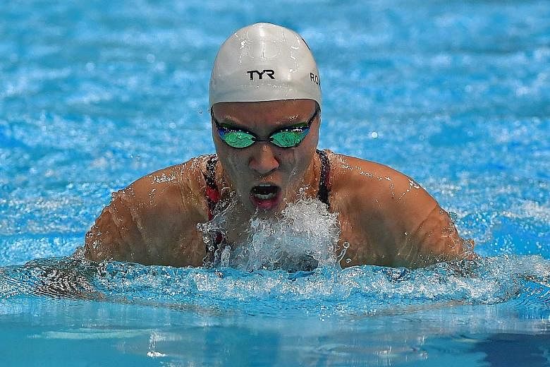 Right: National swimmer Quah Zheng Wen broke his own national record in the 200m backstroke at the Singapore National Swimming Championships heats yesterday, clocking 2:00.45 to erase his previous mark of 2:00.55. Below: Roanne Ho clocked 31.66sec in