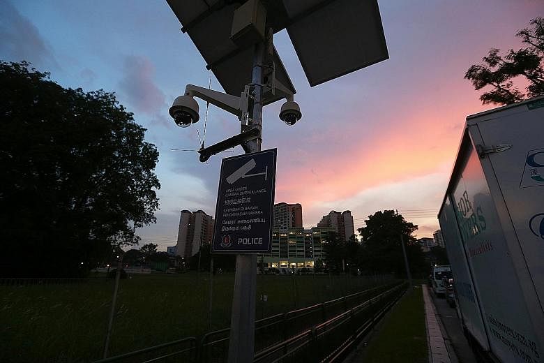 Residents of Choa Chu Kang North can now use a stretch of the Rail Corridor near Sungei Kadut Avenue (left) without being harassed, after a security camera curbed the activities of pimps and contraband cigarette sellers. But police cameras at the Yew