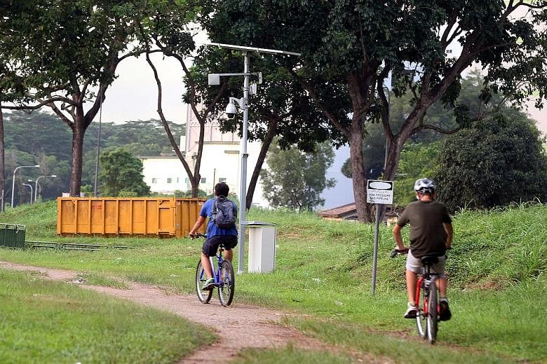 Residents of Choa Chu Kang North can now use a stretch of the Rail Corridor near Sungei Kadut Avenue (left) without being harassed, after a security camera curbed the activities of pimps and contraband cigarette sellers. But police cameras at the Yew