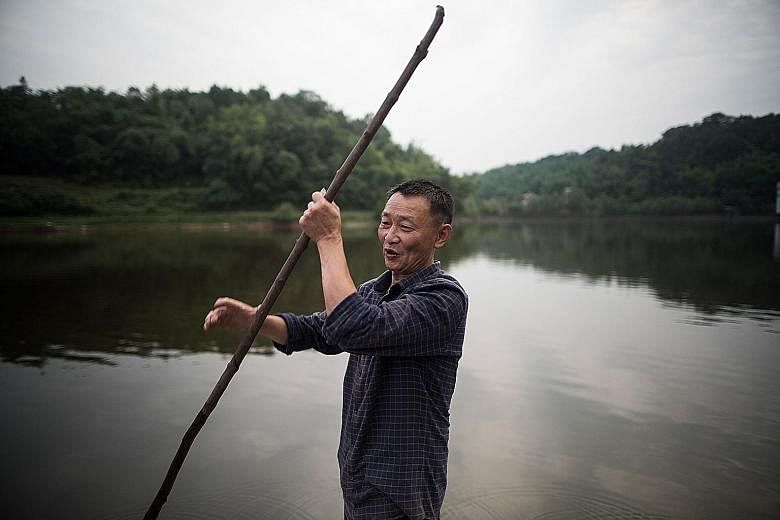 Mr Li Congshu ferrying his pupils after school in Dazu district in south-west China's Chongqing municipality. He has been transporting pupils to and from school for more than 20 years. The crossing of the Xiangshuitan reservoir by boat takes about ha