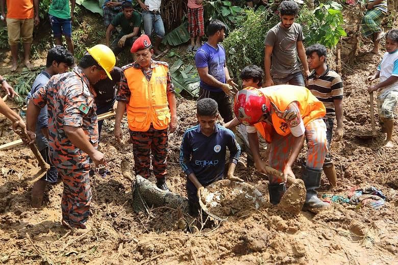 Bangladeshi firefighters recovering a body after a landslide in Rangamati last week. Bangladesh was hit by the worst mudslides on record last week, killing 158.