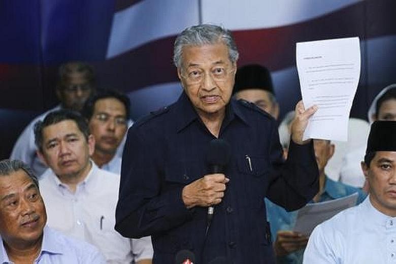 Dr Mahathir Mohamad (left) has been lobbying opposition chiefs to accept him and his deputy Muhyiddin Yassin as the alliance's top two leaders.