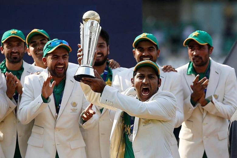 Pakistan players celebrating with the ICC Champions Trophy on Sunday after their comprehensive 180-run victory over India, who had trounced them in the first group game.