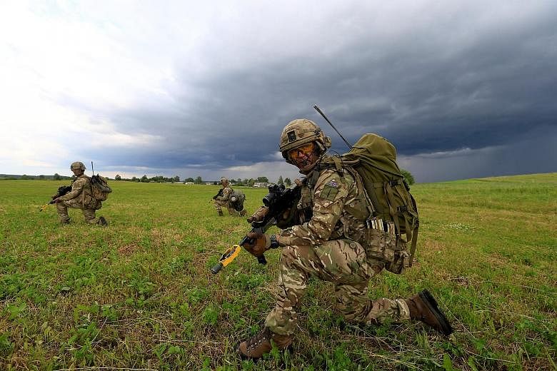 British army soldiers taking part in the Suwalki Gap defence exercise in Mikyciai, Lithuania, last Saturday. The Gap is an area that forms the border between Poland and Lithuania. It runs for 104km through farmland, woods and low hills, and is vulner