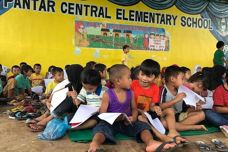 Children putting into drawing what they experienced before fleeing Marawi city at an elementary school in Lanao del Norte in the Philippines this month. Educating the next generation of Muslim youth will go a long way towards slowing the tide of ISIS