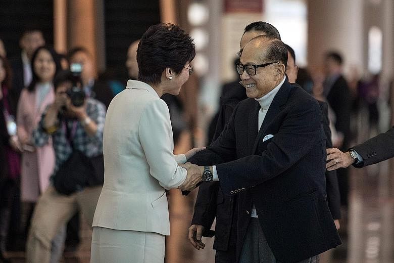 Mr Li Ka Shing with Ms Carrie Lam, before she became Hong Kong Chief Executive-elect. He could step down by his 90th birthday next year, said the Wall Street Journal, though no announcement has been made.